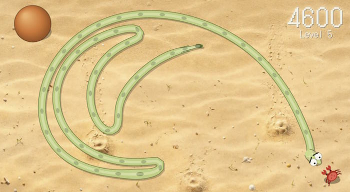 Snake Jungle gameplay on the beach at Level 5: the snake lays long loops across the sand while a crab waits at the edge