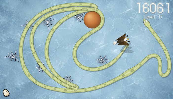 Snake Jungle gameplay on the frozen lake at Level 17: ice cracks all over the field, the orange ball and an eagle diving at the snake